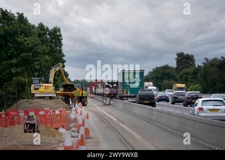 Traffico che passa davanti ai lavori stradali sull'autostrada M1, Inghilterra. Foto Stock