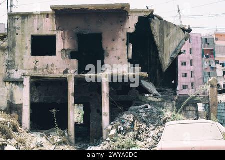 La memoria rimane sulle cicatrici del conflitto, come si può notare negli edifici pieni di proiettili del campo profughi di Sabra-Shatila in Libano Foto Stock