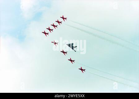 La Royal Air Force Red Arrows mostra squadra in formazione con un caccia furtivo Lockheed F-117A Nighthawk della USAF al Royal International Air Tattoo Airshow alla RAF Fairford, Gloucestershire, Regno Unito. Lo "Stealth Fighter" è stato pilotato da un ex pilota di Red Arrows in cambio della US Air Force Foto Stock