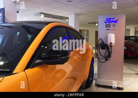 2023 Orange Ford Mustang GT Mach-e SUV elettrico GT AWD in esposizione nello showroom dell'auto, Regno Unito Foto Stock
