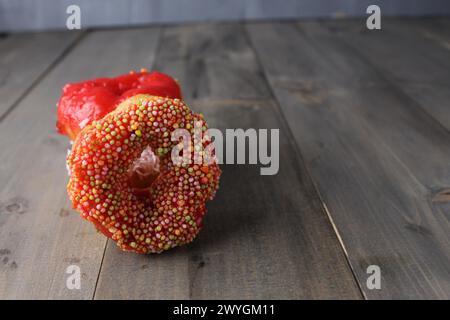 Ciambella in colorazioni multicolore su sfondo grigio con spazio per testo copyspace. Donut Day Sweet Food zucchero carboidrati malsani. Foto Stock