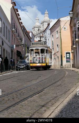 Il famoso tram giallo attraversa i quartieri più antichi, Lisbona, Portogallo. Il tram giallo è molto popolare tra i turisti. Foto Stock