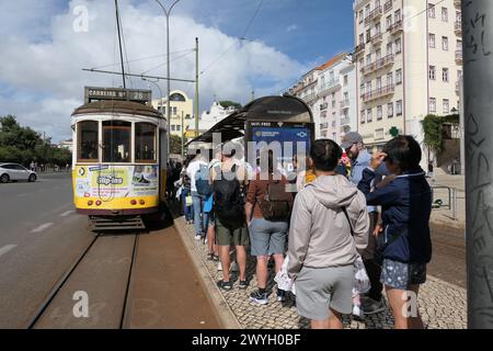Il famoso tram giallo attraversa i quartieri più antichi, Lisbona, Portogallo. Il tram giallo è molto popolare tra i turisti. Foto Stock