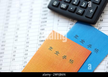 Opuscoli di assicurazione pensionistica giapponese sul tavolo con calcolatrice sul tavolo da vicino Foto Stock