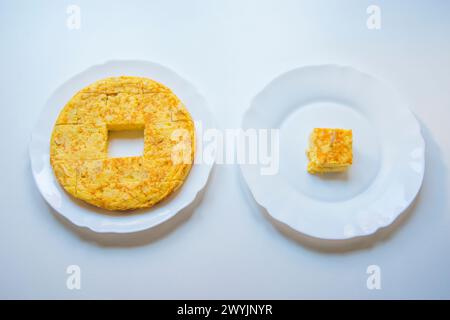 Frittata spagnola tagliato a pezzi in un piatto e un pezzo di esso in un altro piatto. Foto Stock