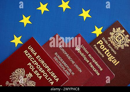 Passaporti dei paesi dell'unione europea con bandiera blu dell'UE da vicino. Passaporti di Portogallo, Germania, Francia e Polonia Foto Stock