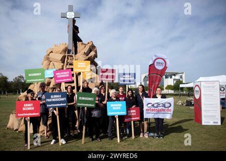 Erlassjahr protesta Agenda 2030 DEU, Deutschland, Germania, Berlino, 18.09.2023 Aktivisten von erlassjahr Brot fuer die Welt und Katholischer Fonds mit Symbol Schuldenberg und Kreuz Rip Agenda 2030 unter dem motto MIT Schulden fair verfahren Koalitionsvertrag umsetzen Staateninsolvenzverfahren schaffen auf dem Platz der Republik a Berlino Deutschland. Die Demonstranten protestieren fuer die Einhaltung der Agenda 2030 mit den Zielen Hunger und Armut beenden, Lebensgrundlagen bewahren, Gesundheit und Bildung fuer alle - fuer nachhaltige Entwicklung die die internationale Gemeinschaft bis zum Jahr Foto Stock