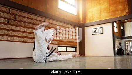 Studenti della cintura nera, lanciano o sensei nel dojo per iniziare una lezione di pratica, disciplina o insegnamento di autodifesa. Padrone giapponese, persone che imparano il combattimento o.. Foto Stock