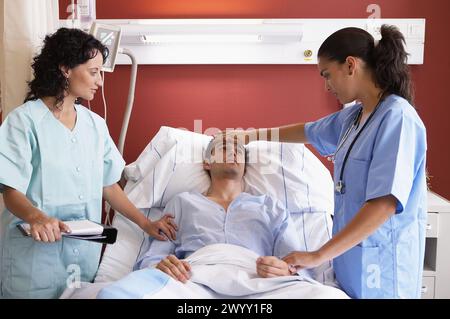 Medici e pazienti in ricovero ospedaliero. Foto Stock