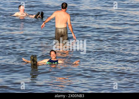 Una donna sorride mentre galleggia nel Mar morto, Israele. Foto Stock