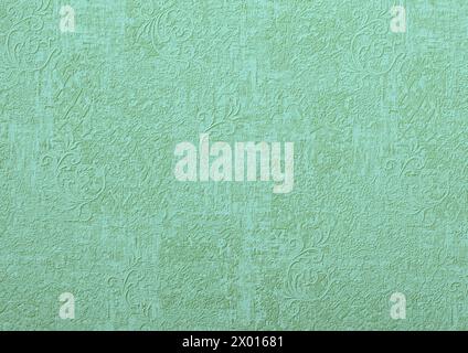 Sfondo di carta da parati verde o parete in gesso con motivo a vortice vintage. Foto Stock