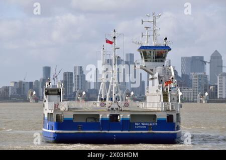 Woolwich Ferry BEN WOOLLACOTT addestramento dell'equipaggio sul Tamigi con lo skyline di Canary Wharf e la barriera del Tamigi sullo sfondo Foto Stock