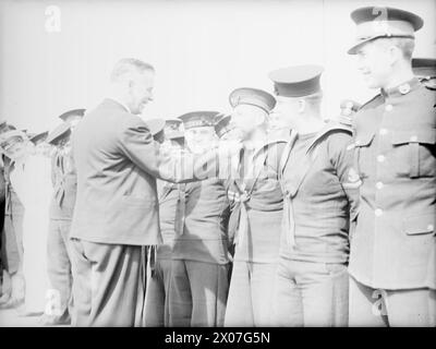 I NEOZELANDESI DELLA ROYAL NAVY INCONTRANO IL LORO MINISTRO DELLA DIFESA. 14 APRILE 1943, PORTSMOUTH, DURANTE LA VISITA IN GRAN BRETAGNA, IL SIG. FRED JONES, MINISTRO DELLA DIFESA NEOZELANDESE, HA INCONTRATO ALCUNI DEI SUOI CONNAZIONALI CHE PRESTANO SERVIZIO NELLA ROYAL NAVY. - Il signor Jones ammirava la barba indossata da Stoker W W Richardson, del 110 Willis Street, Wellington, nuova Zelanda Foto Stock