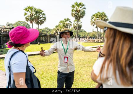 Una guida turistica esperta ti farà conoscere la storia dell'antico tempio indù di Angkor Wat ai turisti interessati a Siem Reap, Cambo Foto Stock