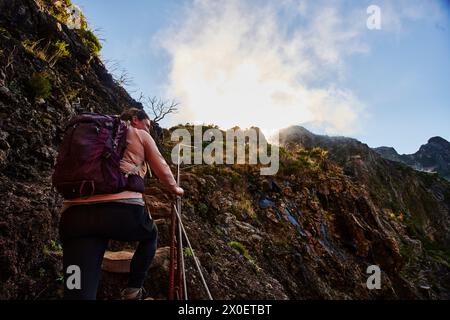 Escursionista femminile che gode del sentiero PR1, Pico do Arierio fino a Pico Ruivo, sull'isola di Madeira, Portogallo, Europa Foto Stock