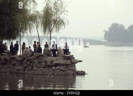 Persone nel parco del palazzo estivo dell'imperatore nel distretto di Dazu a Chongqing in Cina. Sullo sfondo c'è un ponte. Foto Stock