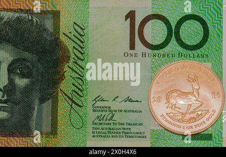 1 oncia originale moneta d'oro Kruger Rand sudafricano 24 carati contro diverse comuni valute di carta fiat; dollaro australiano; negozio di valore. Foto Stock