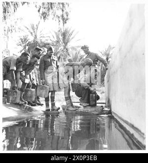 FOTO INCIDENTALI SCATTATE CON L'OTTAVO ESERCITO DURANTE IL LORO ATTACCO E CAPTUREOF LA LINEA MARETH - che si rifornisce al punto d'acqua nel villaggio di Mareth. Negativo fotografico, British Army Foto Stock