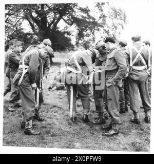 I paracadutisti addestrati regolano le loro imbracature per paracadute prima di un salto controllato da una torre a Elie, Fifeshire. L'esercitazione fa parte dell'addestramento della 4th Cadre Rifle Brigade, dimostrando adeguate tecniche di atterraggio sotto la supervisione del generale Sikorski. Foto Stock