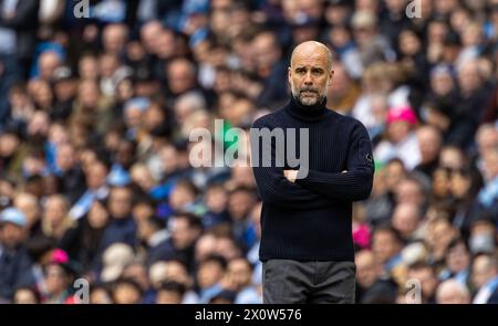 (240414) -- MANCHESTER, 14 aprile 2024 (Xinhua) -- il manager del Manchester City Pep Guardiola reagisce durante la partita di Premier League inglese tra Manchester City e Luton Town a Manchester, Regno Unito, 13 aprile 2024. (XINHUA) SOLO PER USO EDITORIALE. NON IN VENDITA PER CAMPAGNE PUBBLICITARIE O DI MARKETING. DIVIETO DI UTILIZZO CON AUDIO, VIDEO, DATI, ELENCHI DI INCONTRI, LOGHI CLUB/LEAGUE O SERVIZI "LIVE" NON AUTORIZZATI. UTILIZZO ONLINE IN-MATCH LIMITATO A 45 IMMAGINI, SENZA EMULAZIONE VIDEO. NON È CONSENTITO L'USO IN SCOMMESSE, GIOCHI O PUBBLICAZIONI PER SINGOLI CLUB/CAMPIONATO/GIOCATORI. Foto Stock