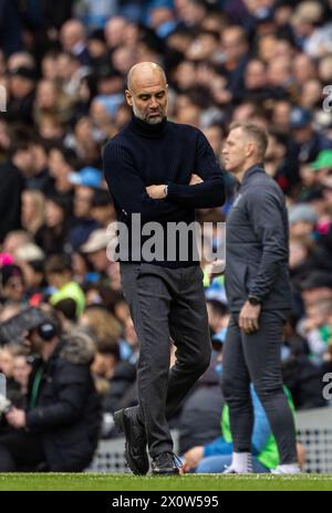 (240414) -- MANCHESTER, 14 aprile 2024 (Xinhua) -- il manager del Manchester City Pep Guardiola reagisce durante la partita di Premier League inglese tra Manchester City e Luton Town a Manchester, Regno Unito, 13 aprile 2024. (XINHUA) SOLO PER USO EDITORIALE. NON IN VENDITA PER CAMPAGNE PUBBLICITARIE O DI MARKETING. DIVIETO DI UTILIZZO CON AUDIO, VIDEO, DATI, ELENCHI DI INCONTRI, LOGHI CLUB/LEAGUE O SERVIZI "LIVE" NON AUTORIZZATI. UTILIZZO ONLINE IN-MATCH LIMITATO A 45 IMMAGINI, SENZA EMULAZIONE VIDEO. NON È CONSENTITO L'USO IN SCOMMESSE, GIOCHI O PUBBLICAZIONI PER SINGOLI CLUB/CAMPIONATO/GIOCATORI. Foto Stock