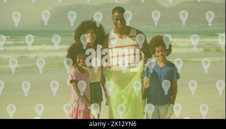 Immagine delle icone delle lampadine sulla famiglia afroamericana che separa i rifiuti Foto Stock