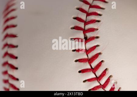 palla da baseball bianca legata con filo rosso, una vera palla da baseball rotonda in primo piano Foto Stock