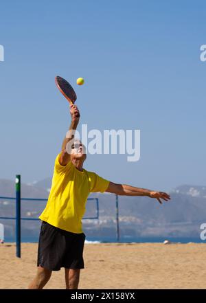 Uomo anziano che gioca a Beach tennis. Sport estivi Foto Stock