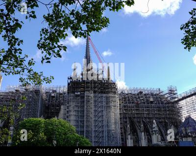 Parigi, Francia, Europa. 15 aprile 2024: Nel 5° anniversario dell'incendio che ha distrutto gran parte della Cattedrale di Notre Dame, i lavoratori sono impegnati a rimuovere alcune impalcature dalla guglia appena installata e a continuare a restaurare l'edificio con l'avvicinarsi dell'apertura al pubblico nel dicembre 2024. Foto Stock