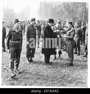 ISPEZIONE DELLE TRUPPE DI TERRANOVA DA PARTE DEL TENENTE GENERALE N.M. RITCHIE, CBE, DSO, MC. Il signor D.J. Davies presenta shamrock agli ufficiali di sezione del reggimento per la distribuzione agli uomini dell'esercito britannico Foto Stock