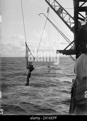 Il 18 gennaio 1943 nell'Oceano Indiano, la HMS Illustrious ha salvato un equipaggio aereo dal mare utilizzando reti salvavita dopo un atterraggio difettoso durante un pattugliamento antisommergibile, segnando il primo salvataggio noto del personale di trasporto con questo metodo. Foto Stock