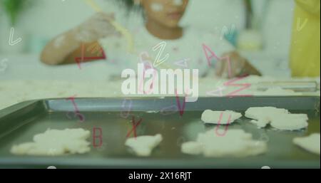 Immagine di lettere e numeri che cadono sopra una ragazza afroamericana che prepara biscotti Foto Stock