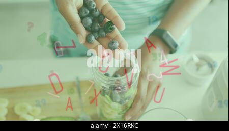 Immagine di lettere e numeri che cadono sopra una donna caucasica che prepara la colazione con le bacche Foto Stock