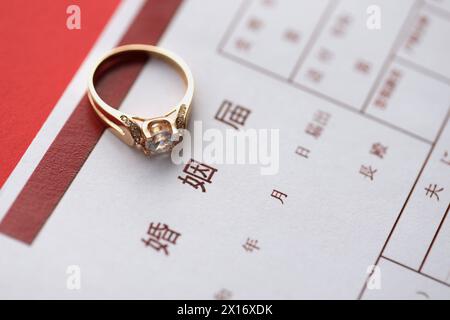 Documento in bianco di registrazione del matrimonio giapponese e anello della proposta di matrimonio sul tavolo da vicino Foto Stock