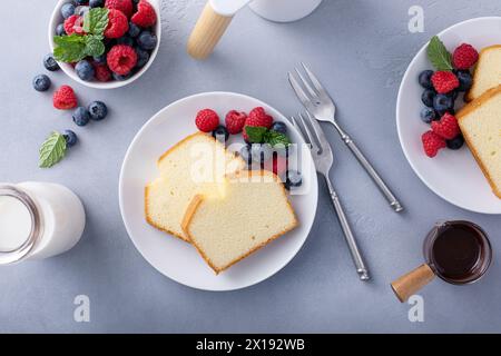 Libbra fette di torta servite con frutti di bosco freschi, sciroppo al cioccolato e caffè Foto Stock