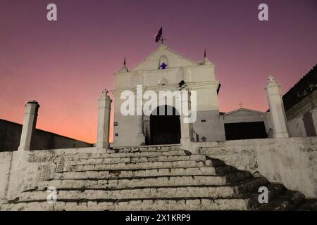 Vista esterna della piccola cappella El Calvario al tramonto a Chichicastenango, Guatemala. La Chiesa cattolica e le credenze maya si mescolarono molto tempo fa nelle regioni indigene del Guatemala in un processo chiamato sincretismo. Foto Stock