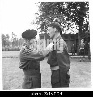 IL FELDMARESCIALLO MONTGOMERY DECORA LE TRUPPE CANADESI DOPO IL SUO 'INCIDENTE AEREO il C-in-C presentando medaglie - M. C. - Capitano W.A. Walker 2/14 CDN.FD.Regt.RCA[CAOF] , British Army, 21st Army Group Foto Stock