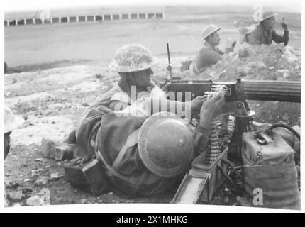 FOTO SCATTATE FUORI DERNA - con un battaglione di mitragliatrici. Immagini che mostrano il trasporto della pistola in avanti, il caricamento delle cinture di munizioni, l'utilizzo del telemetro e il battaglione in azione. Ogni cintura contiene 250 colpi di munizioni, British Army Foto Stock