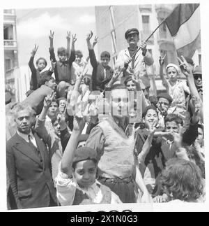 7 MAGGIO 1943 ... PASSANDO A TUNISI, solo una piccola folla di molte centinaia di persone a Tunisi che hanno dato un caloroso benvenuto alle nostre truppe, l'esercito britannico Foto Stock