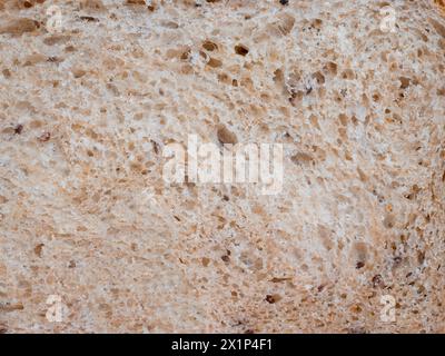 Briciola del pane bianco fatto in casa, primo piano. Fondo di grana fetta di pane Foto Stock