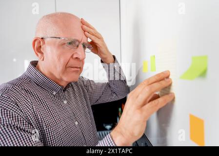 Uomo anziano con demenza. L'uomo anziano affetto da demenza ha difficoltà a ricordare Foto Stock