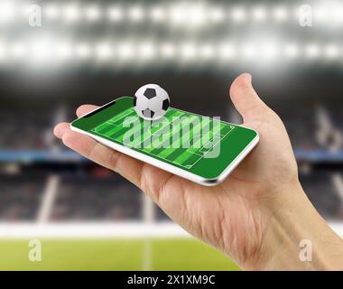 Ripresa ritagliata di un uomo utilizzando uno smartphone come campo di calcio, guardare online, scommettere concetto online allo stadio Foto Stock