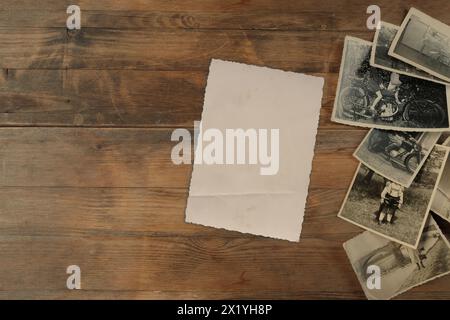 pila di vecchie fotografie monocromatiche d'epoca 1950 su carta fotografica su sfondo in legno naturale, concetto di genealogia, memoria degli antenati, famiglia t Foto Stock