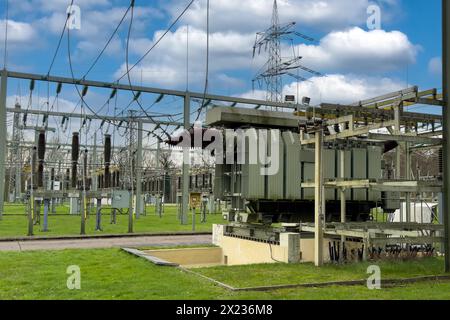 Sottostazione parte di una rete di alimentazione elettrica con generatore di trasformatori nelle linee ad alta tensione di fondo per una maggiore sicurezza Foto Stock