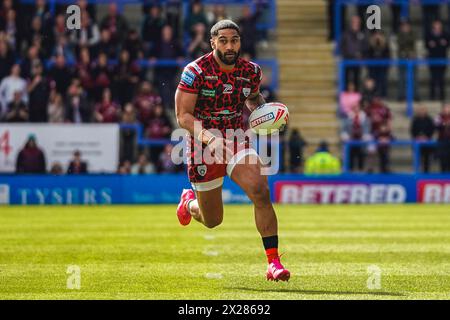 Warrington, Cheshire, Regno Unito. 20 aprile 2024. Super League Rugby: Warrington Wolves vs Leigh Leopards all'Halliwell Jones Stadium. JOHN ASIATA porta la palla in una mano mentre attacca la linea di Warrington. Credito James Giblin/Alamy Live News. Foto Stock