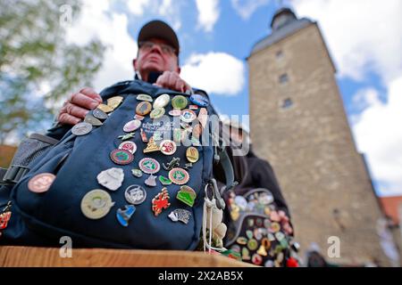 21 aprile 2024, Sassonia-Anhalt, Osterwieck: Uno zaino con numerose spille da trekking si erge su una panchina a Wasserburg Zilly. Nuovi opuscoli a tema e i nuovi pass escursionistici per il 2024 sono stati presentati in occasione dell'apertura della stagione delle pinne di Harz a Wasserburg Zilly. Centinaia di escursionisti sono venuti per celebrare il nuovo anno delle escursioni nelle montagne Harz. Fin dalla sua fondazione, l'Harzer Wandernadel si è sviluppato in un importante fattore economico per il turismo. Ogni anno vengono pubblicati oltre 100.000 opuscoli escursionistici. Un totale di 222 francobolli possono essere raccolti nei luoghi di interesse lungo i percorsi escursionistici designati. T Foto Stock