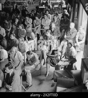 "I lavoratori di guerra in una fabbrica di aeromobili britannica nel 1943 ascoltano l'Hirsch String Quartet che esegue un quartetto a e Flat di Dittersdorf durante un concerto all'ora di pranzo nella mensa della fabbrica, illustrando l'intrattenimento per i lavoratori durante la guerra." Foto Stock