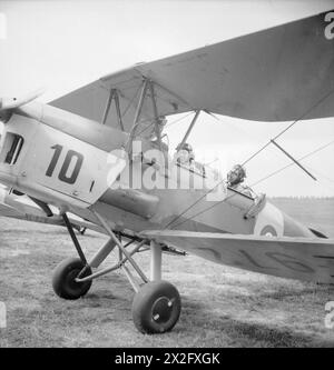 SCUOLA DI ADDESTRAMENTO AEREO BELGA IN GRAN BRETAGNA: FORMAZIONE PRESSO SNAILWELL, CAMBRIDGESHIRE, INGHILTERRA, Regno Unito, 1945 - Un allievo e un istruttore siedono su un aereo Tiger Moth a doppio controllo presso la Belgian Air Training School di Snailwell, vicino a Newmarket. Un gran numero 10 è dipinto sul lato dell'aereo, vicino al naso Foto Stock