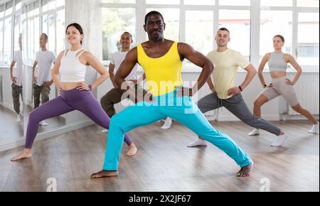 Gruppo di persone che si scaldano prima della lezione di ballo Foto Stock