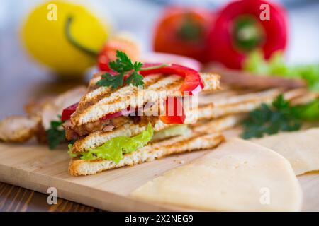 toast fritti con pollo, insalata, verdure su un tavolo di legno. Foto Stock